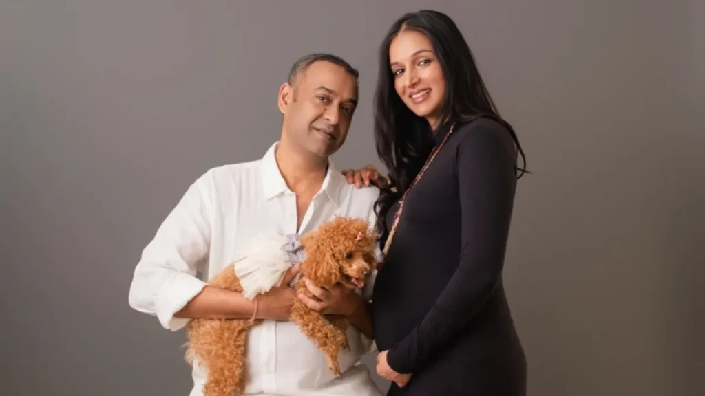 Film producer Madhu Mantena and wife Ira Trivedi smiling during their 2026 maternity photoshoot.