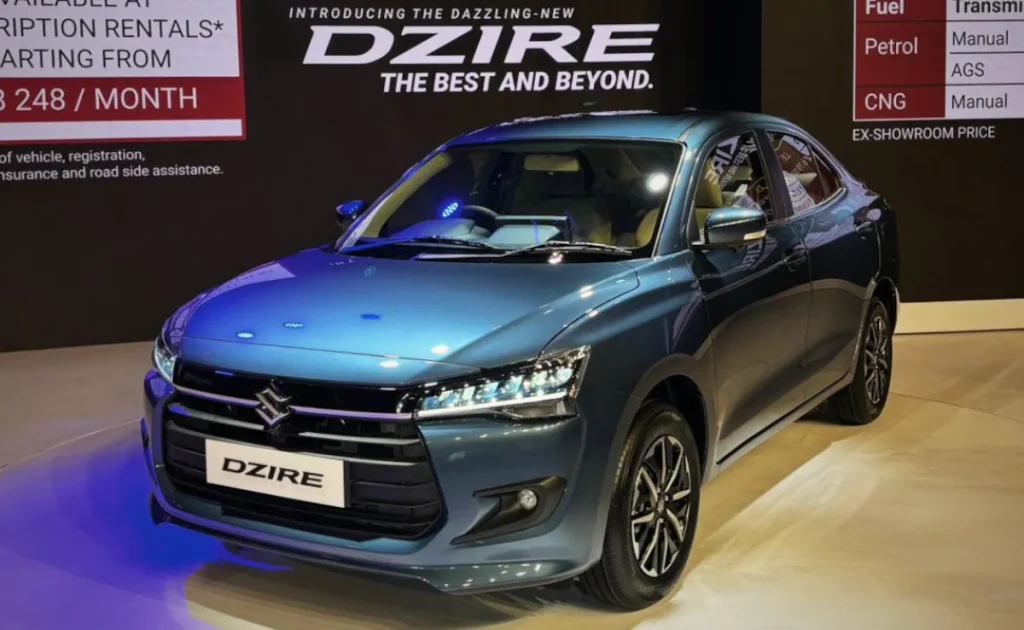 Front profile of the new 2026 Maruti Suzuki Dzire in Light Blue featuring sleek LED headlamps and a premium chrome grille.